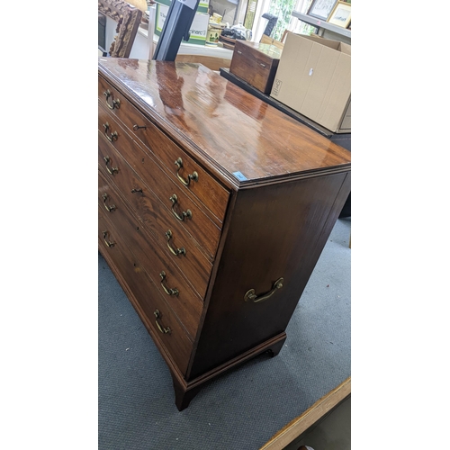 242 - An early 19th century mahogany secretaire chest having a fitted interior above three drawers on brac... 