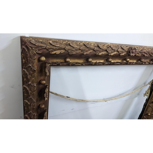 245 - A large Victorian gilt wood picture frame, moulded with acanthus leaves and applied balls, 120h x 10... 