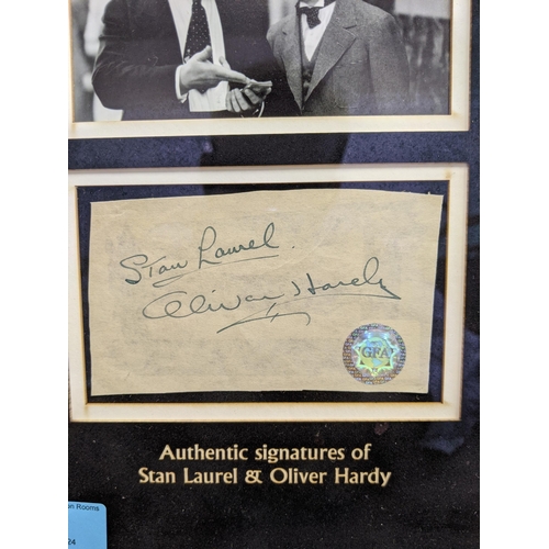 21 - A Laurel & Hardy framed signature cut with two photos and two signatures with a stamp GFA, comes wit... 