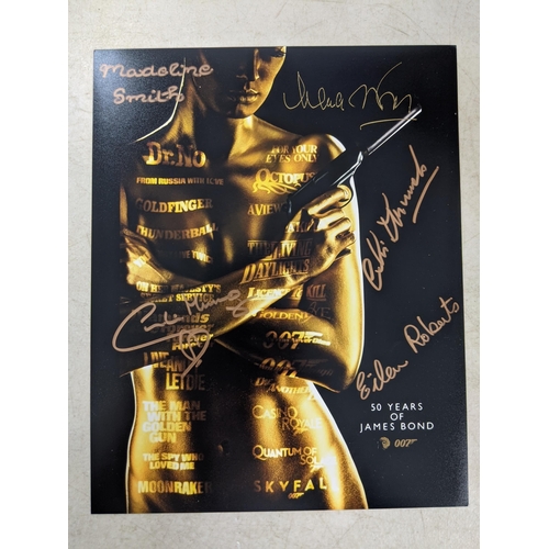 24 - Twelve signed James Bond related items to include a signed 10x8 photograph of Roger Moore and Fiona ... 