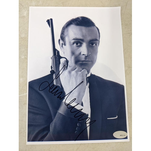 24 - Twelve signed James Bond related items to include a signed 10x8 photograph of Roger Moore and Fiona ... 