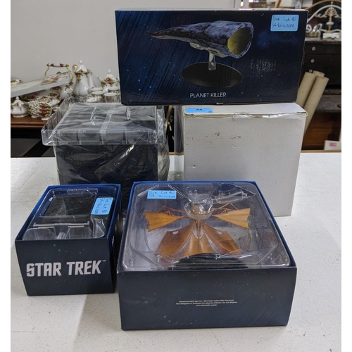 54 - Four Star Trek boxed models to include Planet Killer, Bajoran Lightship, a small model of a Borg Cub... 