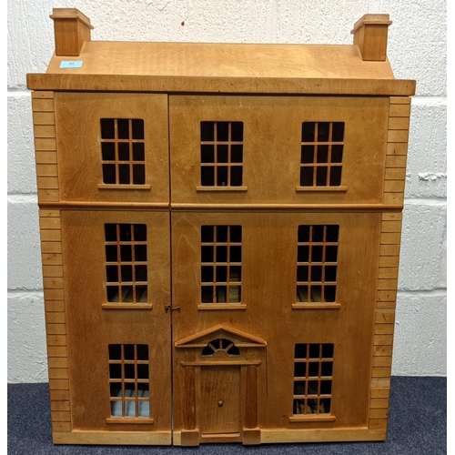 62 - A 1960s wooden Honeychurch dolls house made with Russian plywood and has electrical fittings and a d... 