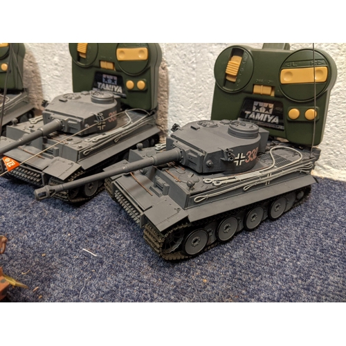 66 - Five Tamiya radio controlled model tanks to include three German tanks, one in camouflage livery
Loc... 