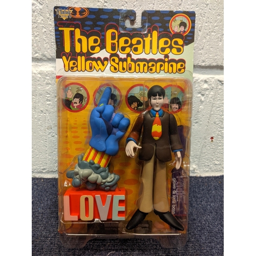 77 - Five McFarlane Toys, The Beatles Yellow Submarine figures to include Paul with Glove and Love Base, ... 