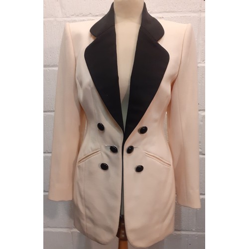 6 - Catherine Walker- A late 20th Century cream tuxedo style longline and fitted wool jacket having blac... 