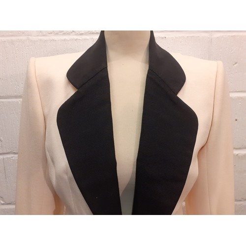 6 - Catherine Walker- A late 20th Century cream tuxedo style longline and fitted wool jacket having blac... 