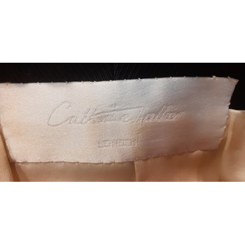 6 - Catherine Walker- A late 20th Century cream tuxedo style longline and fitted wool jacket having blac... 