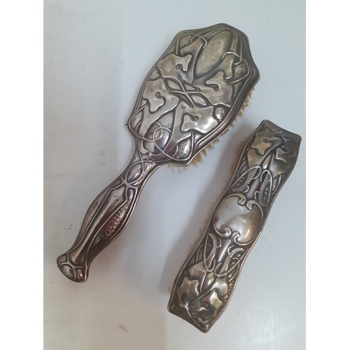 28 - An Art Nouveau silver backed hairbrush and matching clothes brush, makers mark D&F (Deakin & Francis... 