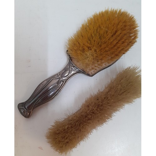 28 - An Art Nouveau silver backed hairbrush and matching clothes brush, makers mark D&F (Deakin & Francis... 