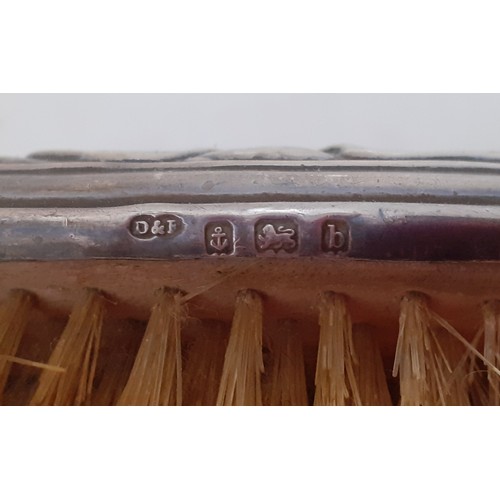 28 - An Art Nouveau silver backed hairbrush and matching clothes brush, makers mark D&F (Deakin & Francis... 