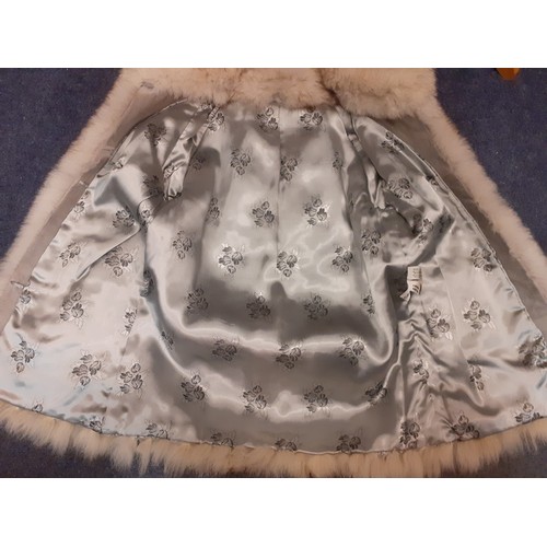 76 - A 1980's silver fox jacket, made in Malta having a vertical cut design with intermittent grey suede ... 