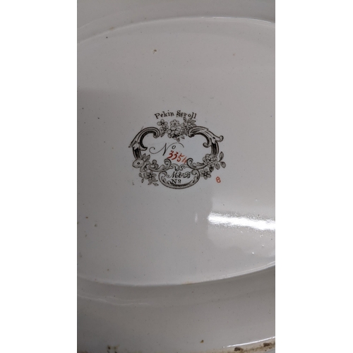 288 - A Minton Pekin Scroll part dinner service including platters, tureens and other items.
Location: 10-... 