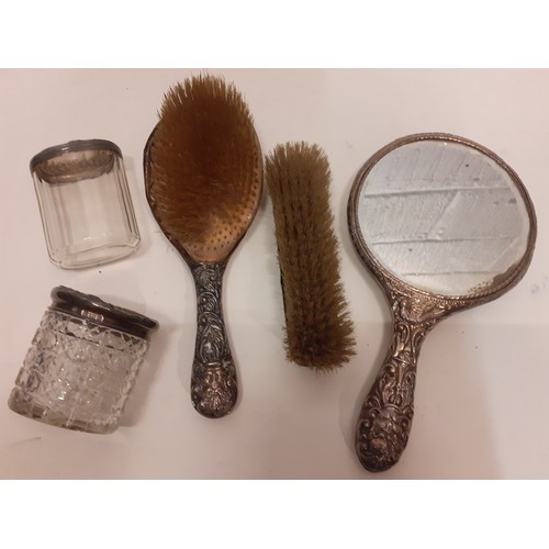 27 - A Victorian silver embossed 5 piece 'matched' dressing table set A/F comprising a hand mirror, a hai... 