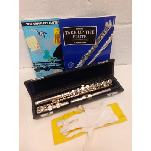 189 - A silver tone flute, no label/name/serial number, in a fitted box together with 2 related books. Loc... 