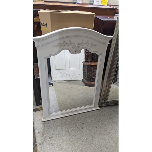 142 - Two modern mirrors to include a white painted mirror having an arched top with applied moulding, 100... 