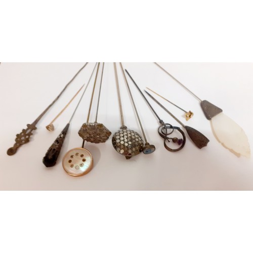 107 - A collection of Victorian and later decorative hat pins to include white metal examples, a small yel... 