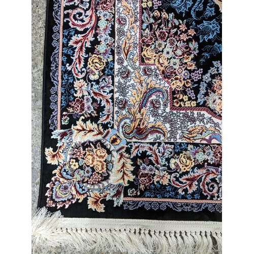 422 - A contemporary small Persian style, machine woven rug, floral design with borders around a central m... 