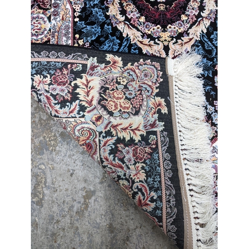 422 - A contemporary small Persian style, machine woven rug, floral design with borders around a central m... 