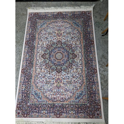 422 - A contemporary small Persian style, machine woven rug, floral design with borders around a central m... 