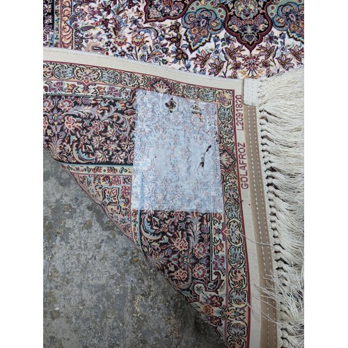 422 - A contemporary small Persian style, machine woven rug, floral design with borders around a central m... 