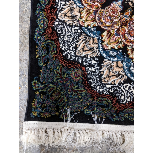 425 - A contemporary small Persian style, machine woven rug, floral design surrounding a central floral me... 