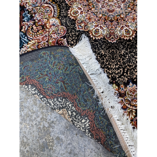 425 - A contemporary small Persian style, machine woven rug, floral design surrounding a central floral me... 