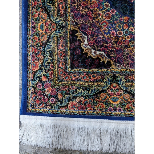 426 - A contemporary small Persian style, machine woven rug, floral design surrounded by a central floral ... 