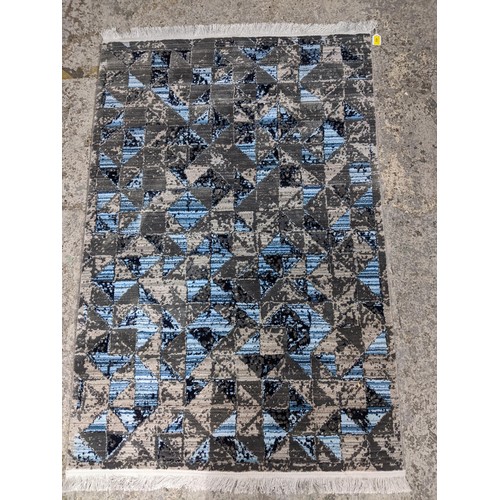 423 - A modern machine woven Persian style rug, ornate design on a dark turquoise ground, triple guard bor... 