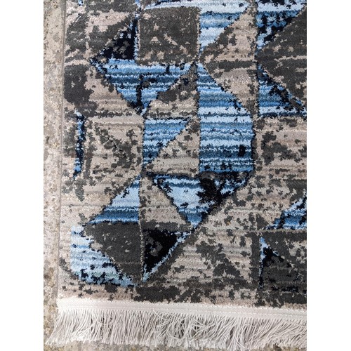 423 - A modern machine woven Persian style rug, ornate design on a dark turquoise ground, triple guard bor... 