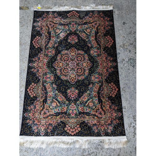 426 - A contemporary small Persian style, machine woven rug, floral design surrounded by a central floral ... 