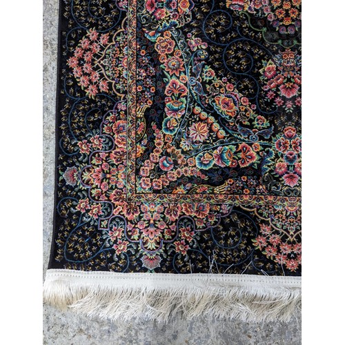 426 - A contemporary small Persian style, machine woven rug, floral design surrounded by a central floral ... 