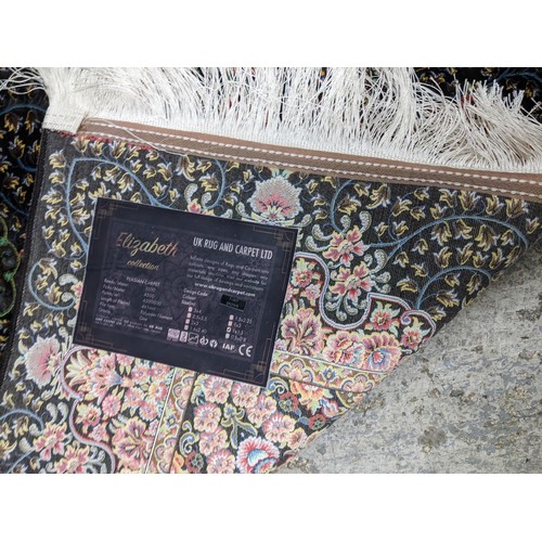 426 - A contemporary small Persian style, machine woven rug, floral design surrounded by a central floral ... 