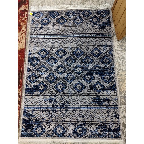 425 - A contemporary small Persian style, machine woven rug, floral design surrounding a central floral me... 