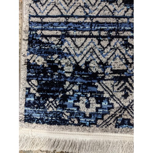 425 - A contemporary small Persian style, machine woven rug, floral design surrounding a central floral me... 