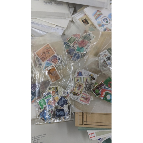 163 - A quantity of first day covers together with mainly British stamps loose and an album of coins form ... 