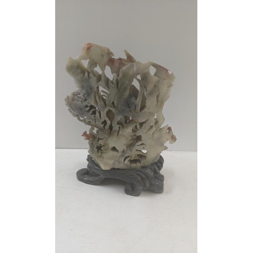 171 - A carved soapstone fish sculpture on an ornately carved soapstone plinth fashioned as an ocean wave
... 