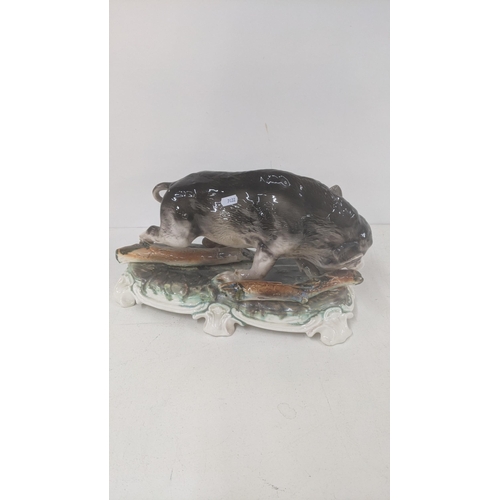 175 - A ceramic sculpture of a boar on a plinth, 42cm w, 22.5cm h
Location: 9-5
If there is no condition r... 