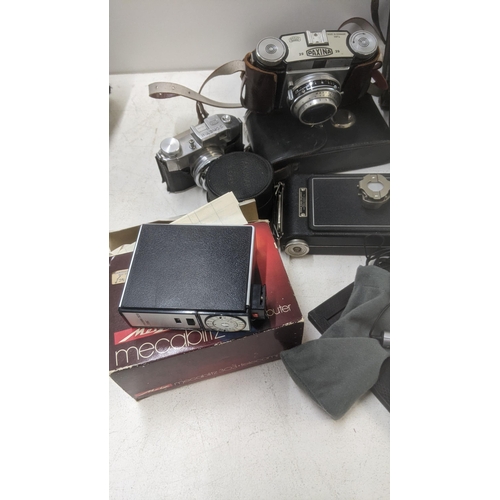 183 - A collection of vintage cameras and camera accessories to include a Paxina Halina Paulette Electric ... 