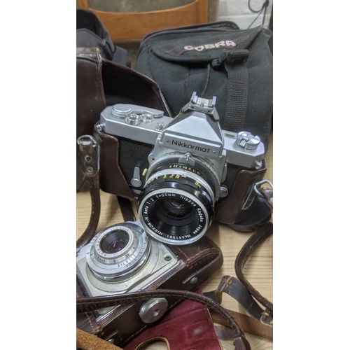 199 - A group of mixed vintage cameras to include a Canon E05 1000, a Contaflex, a Nikkor mat and others t... 