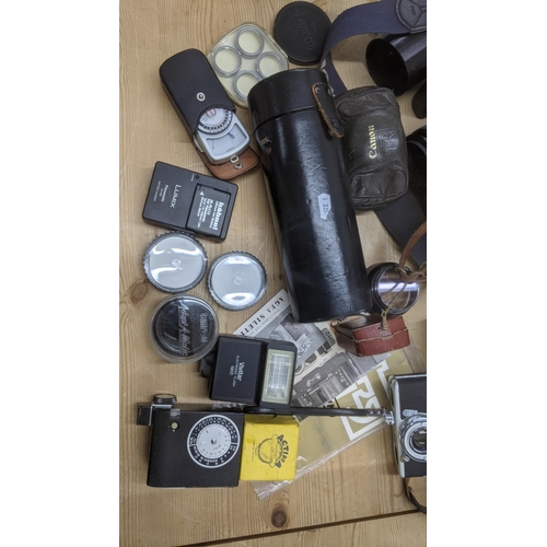 199 - A group of mixed vintage cameras to include a Canon E05 1000, a Contaflex, a Nikkor mat and others t... 