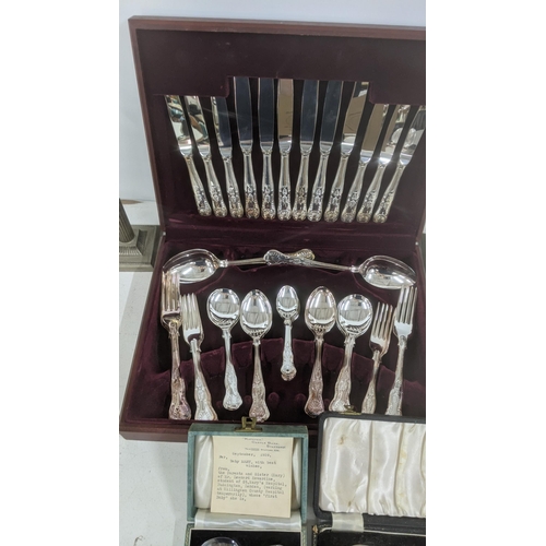 213 - A canteen of silver plated fiddle pattern cutlery and flatware, together with a pair of pewter candl... 