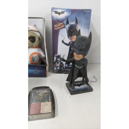 220 - Mixed toy related collectables to include Buck Rogers flask, Batman Head Knocker, a Futurama tin lun... 