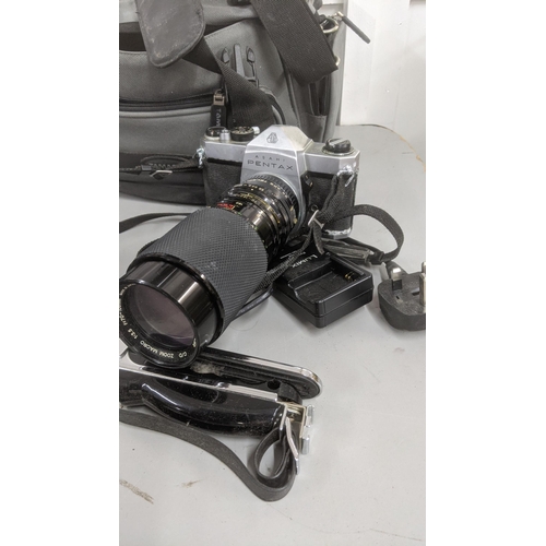 222 - Cameras and camera related accessories to include a Canon AV-1 example, a Panasonic DMC-TZ9 and othe... 