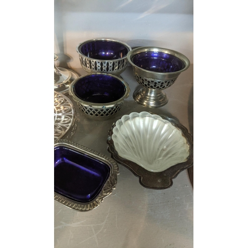 32 - Silver plate to include a three piece tea service, an inkwell fashioned as a horseshoe, sauce boat c... 