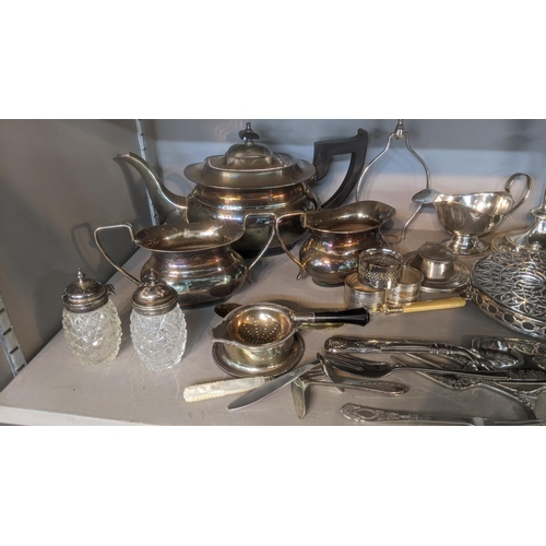 32 - Silver plate to include a three piece tea service, an inkwell fashioned as a horseshoe, sauce boat c... 