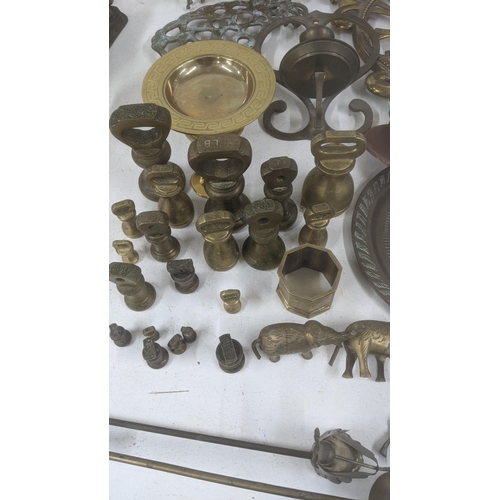 361 - Mixed brassware and metalware to include scale weights, a pair of candlesticks, miniature items made... 