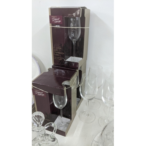 4 - Glassware to include three boxes of Champagne flutes, wine glasses, a crystal cut glass cake dish, a... 