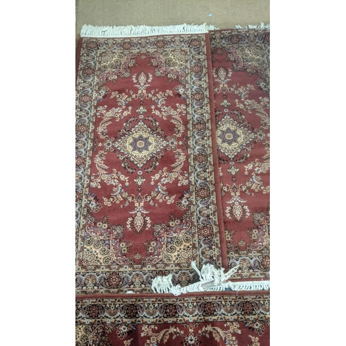 6 - Three Persian style machine made rugs, all on red ground with repeating motifs
Location: RAB
If ther... 