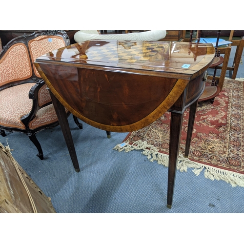 328 - A flame mahogany dropleaf gaming table with a chessboard design on top, a pair of faux drawers with ... 